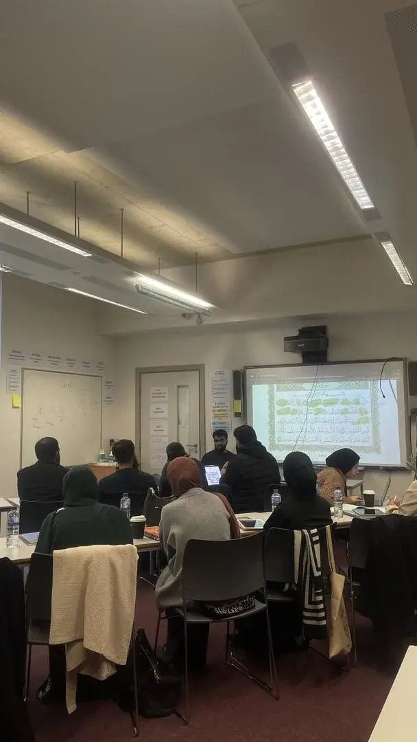 A classroom session working through an ayah on screen